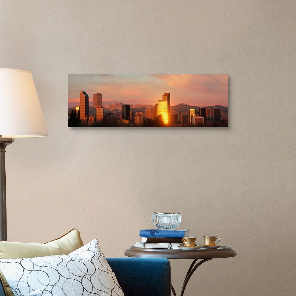 A traditional room featuring A panoramic shot taken of the Denver skyline while the sun is setting and reflecting off some of ...