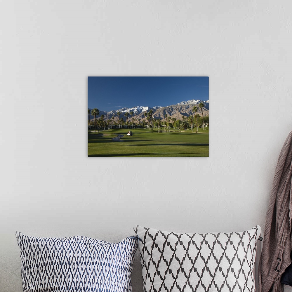 A bohemian room featuring Oversized, horizontal photograph of a golf cart on the green of golf course at the Desert Princes...