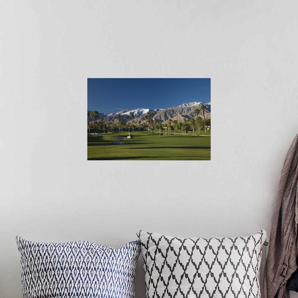 A bohemian room featuring Oversized, horizontal photograph of a golf cart on the green of golf course at the Desert Princes...