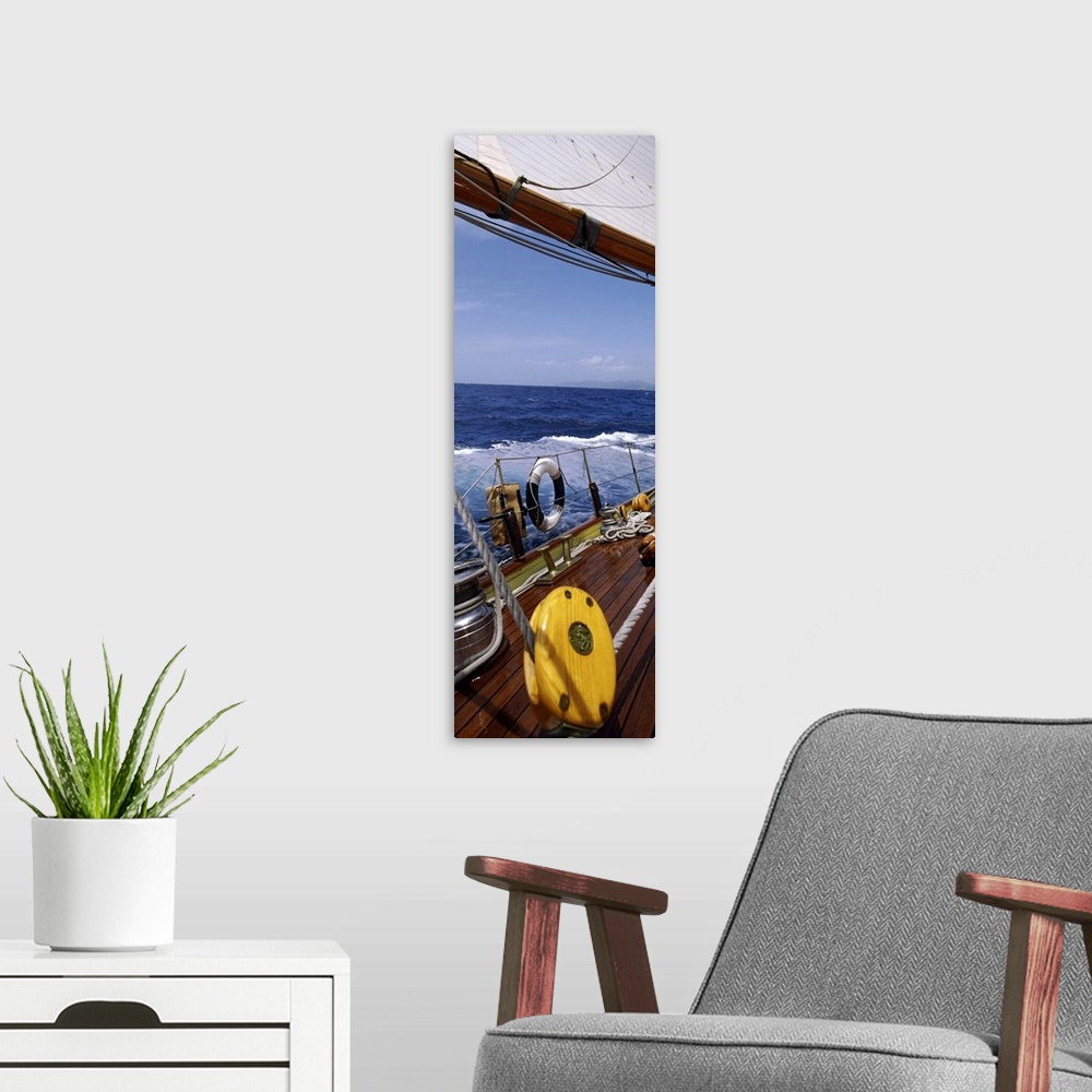 A modern room featuring This photograph is taken on a sailboat showing the detail of the deck on the boat and side railing.