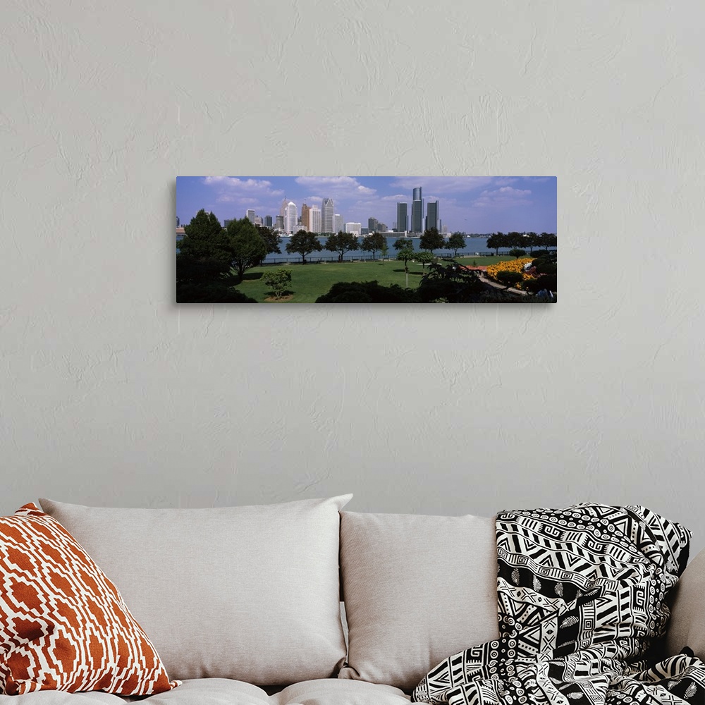 A bohemian room featuring This wall art is a panoramic photograph of the city skyline taken from a park across the water.