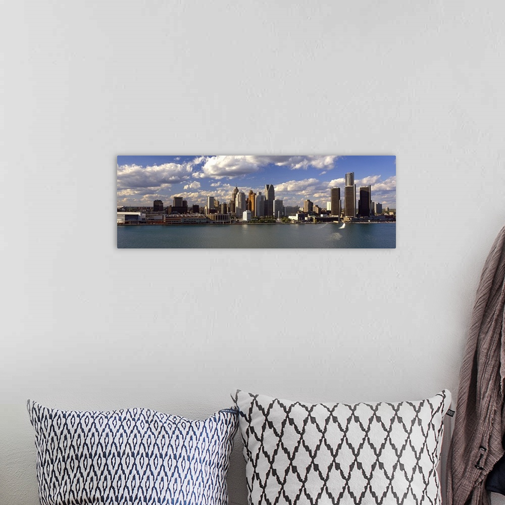 A bohemian room featuring This panoramic photograph shows the city skyline at midday taken from on the water.