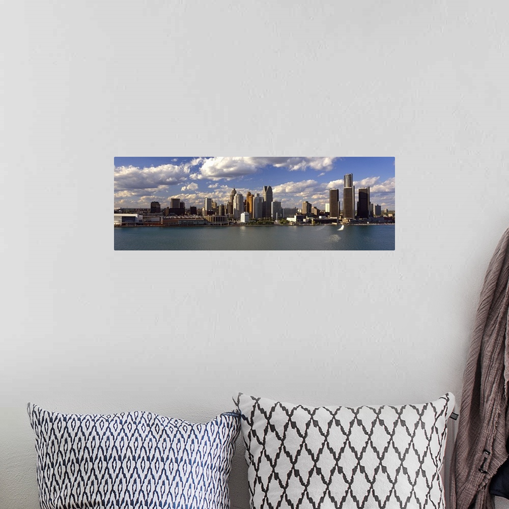 A bohemian room featuring This panoramic photograph shows the city skyline at midday taken from on the water.