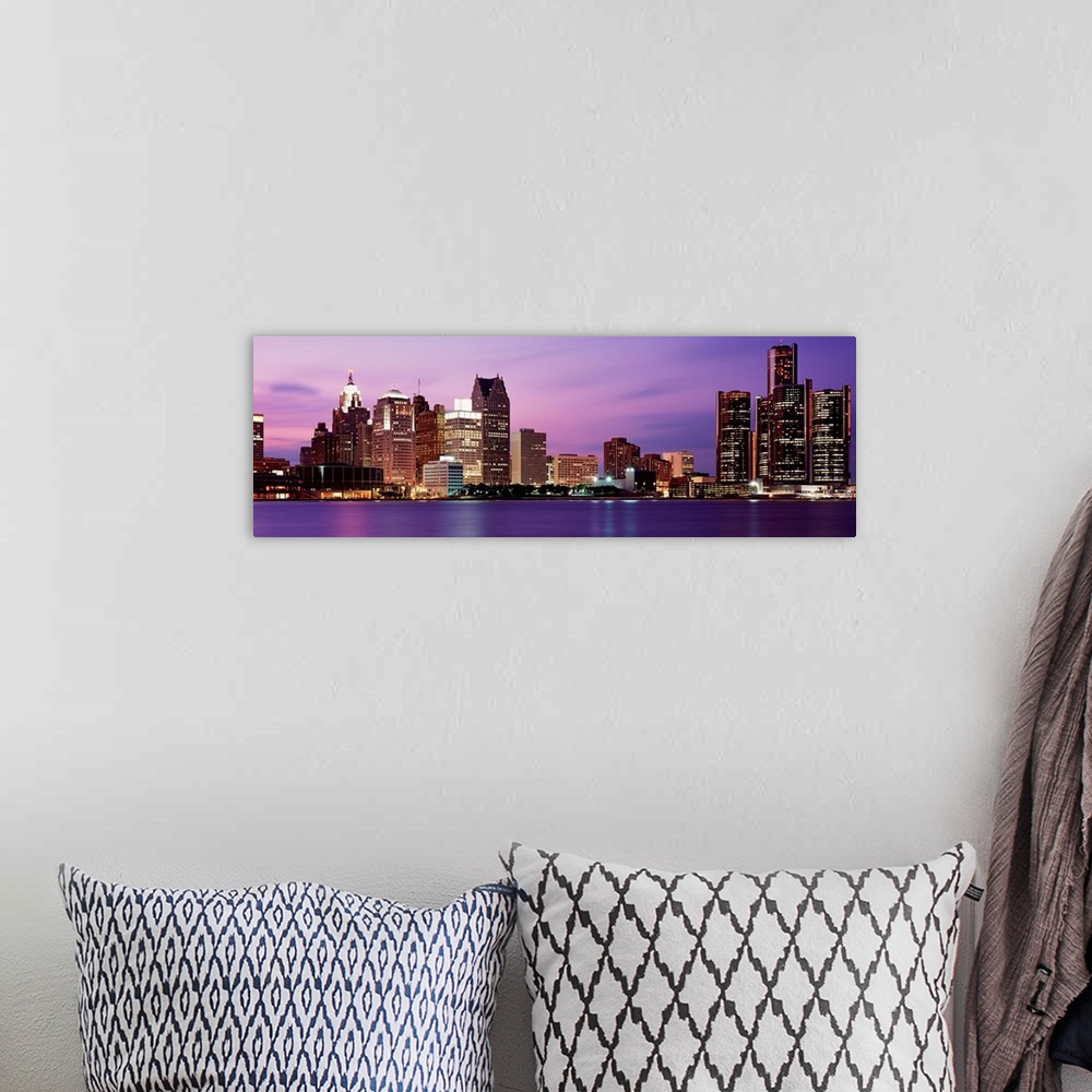 A bohemian room featuring A panoramic photographic taken on a calm evening, this wall art shows the cityscape lit up at nig...