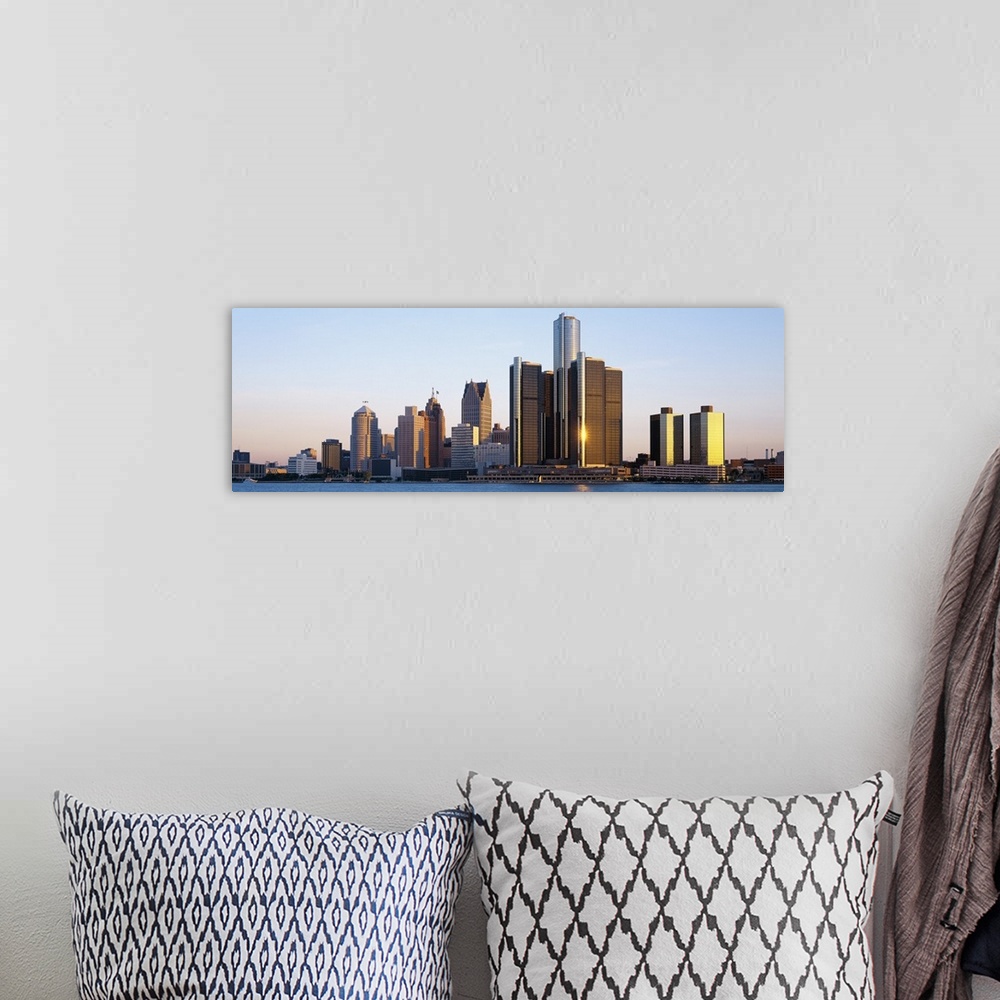 A bohemian room featuring Panoramic photograph of city skyline with waterfront.  The sun is reflecting off one of the skysc...