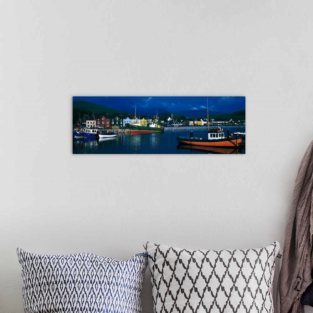 A bohemian room featuring Panoramic photograph of colorful variety of boats in the water, in front of a row of multi-colore...
