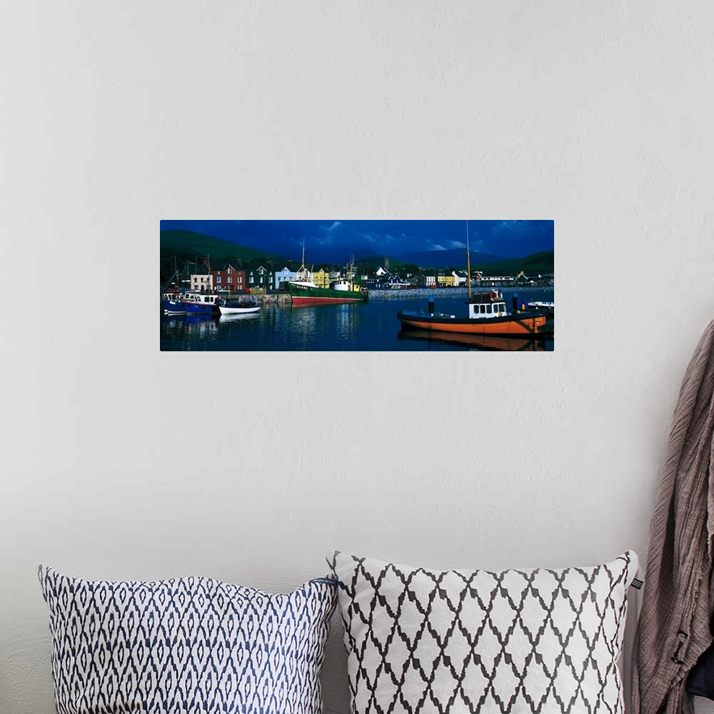 A bohemian room featuring Panoramic photograph of colorful variety of boats in the water, in front of a row of multi-colore...