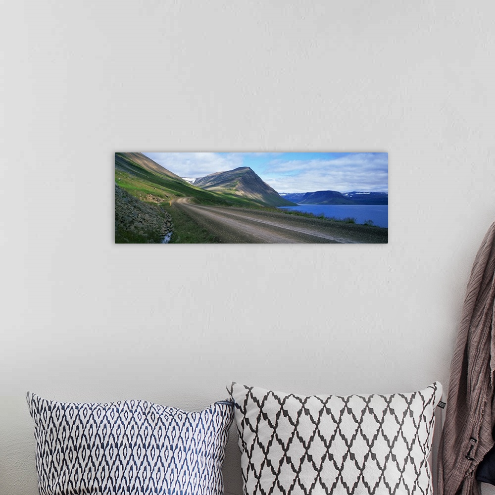 A bohemian room featuring Dirt road along mountain lake, Iceland