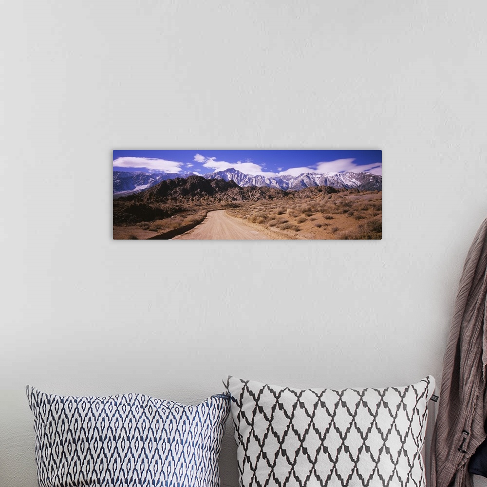 A bohemian room featuring Dirt road passing through an arid landscape, Lone Pine, Californian Sierra Nevada, California