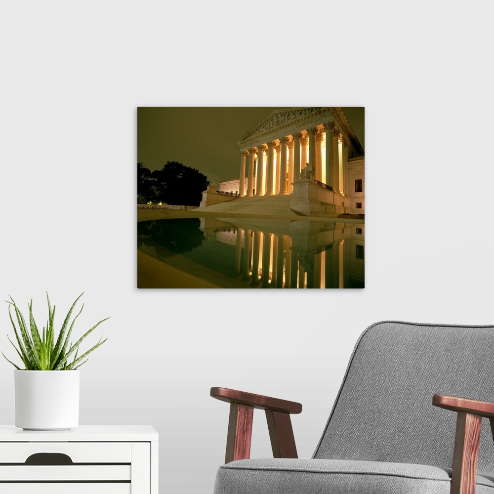 A modern room featuring Photograph taken of the Supreme Court in the capital illuminated at night.