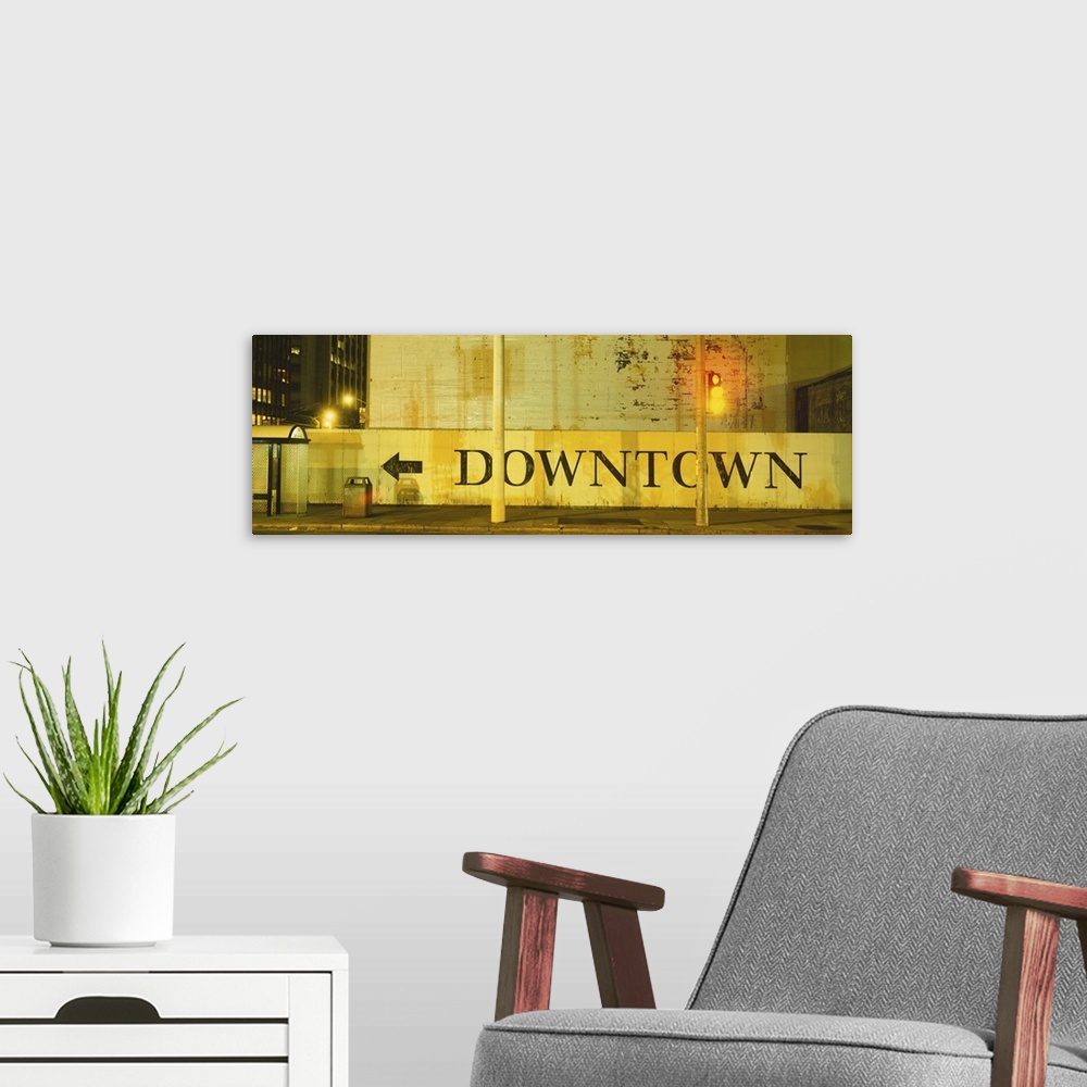 A modern room featuring Large panorama of a half wall in downtown San Francisco with a painted sign on it pointing pedest...