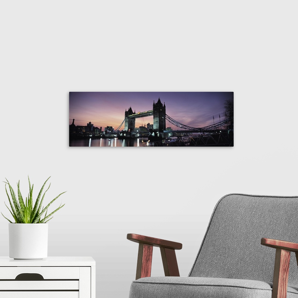 A modern room featuring Drawbridge lit up at dusk Tower Bridge Thames River London England