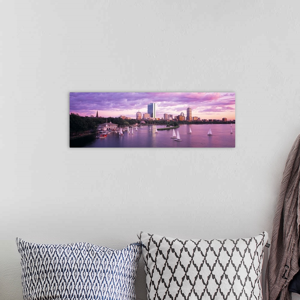 A bohemian room featuring Panoramic photograph of skyline and waterfront at sunset.  There are sailboats in the water under...