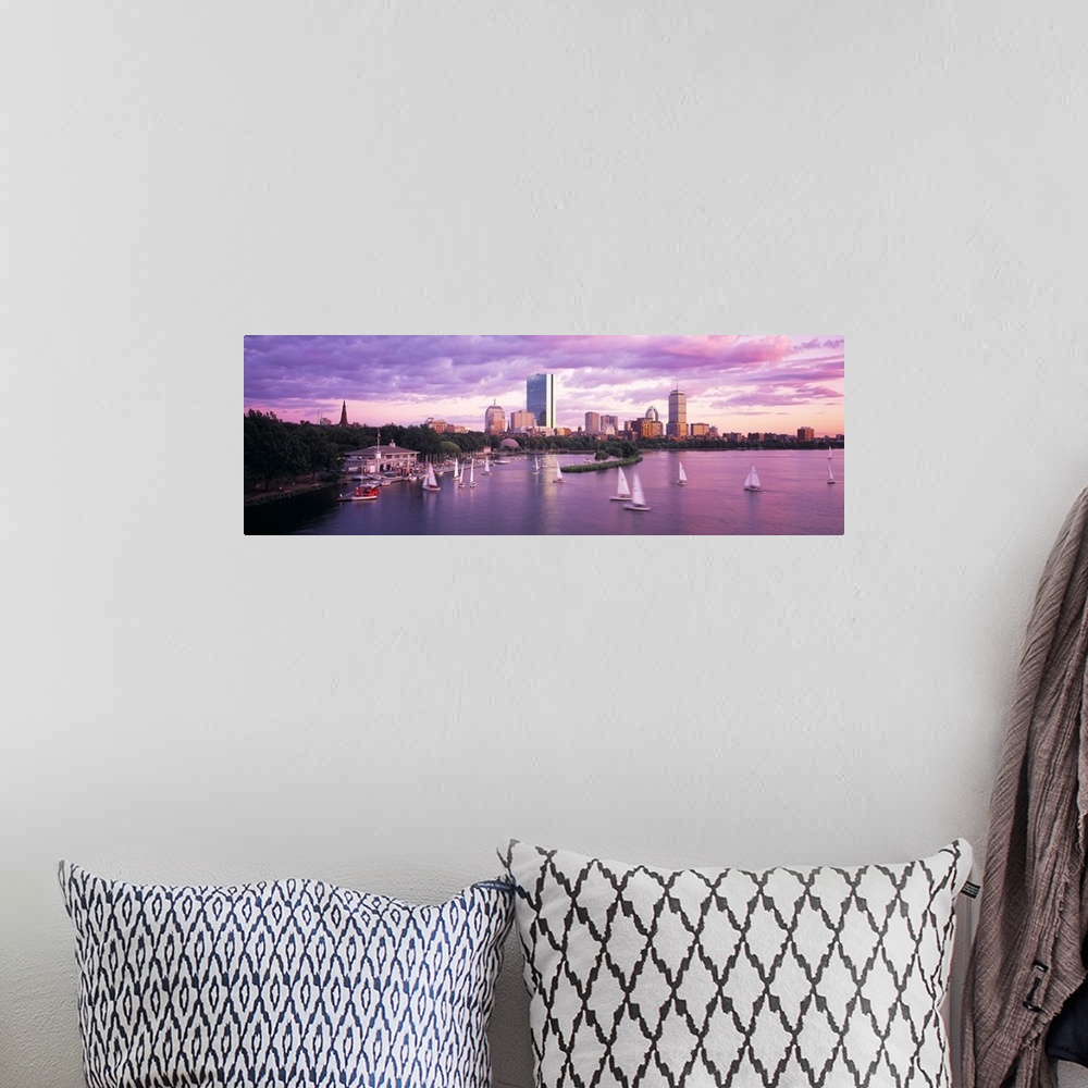 A bohemian room featuring Panoramic photograph of skyline and waterfront at sunset.  There are sailboats in the water under...