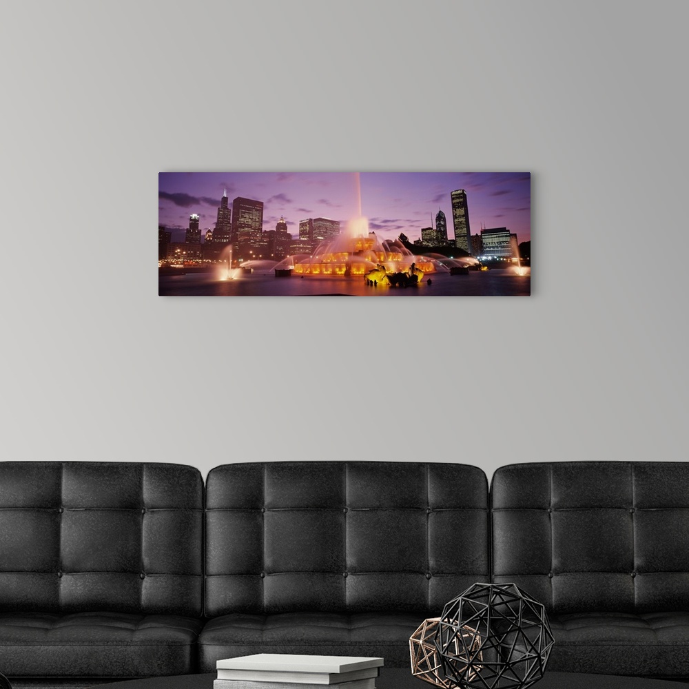 A modern room featuring Panoramic photograph taken of Buckingham Fountain lit up at dusk as it sprays water in an intrica...