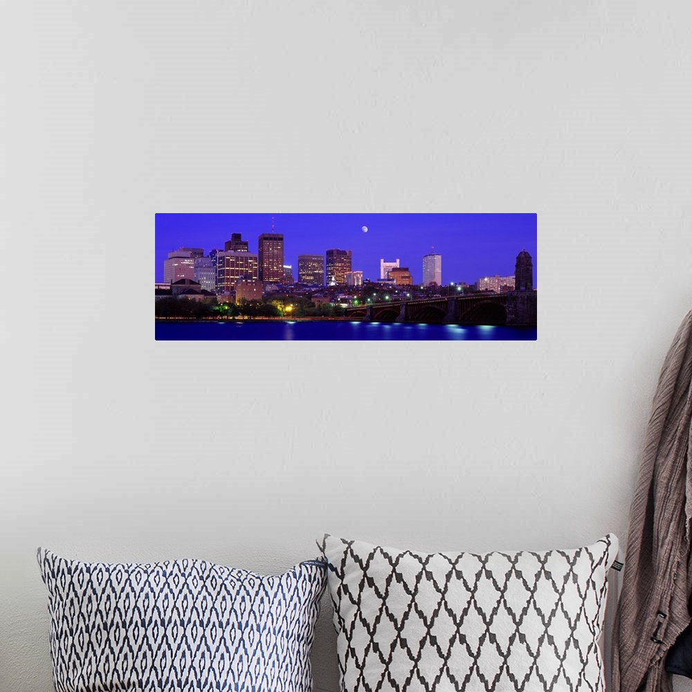 A bohemian room featuring Panoramic canvas of a cityscape on the waterfront with a bridge leading to it and a bright moon i...