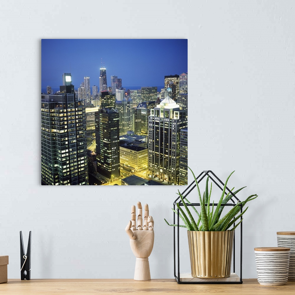 A bohemian room featuring Square photo print of tall buildings in downtown Chicago lit up at night.