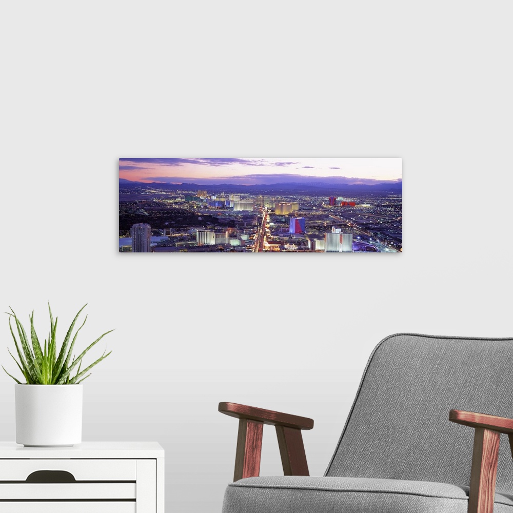 A modern room featuring Aerial shot taken over the city of Las Vegas with casinos, buildings and houses in view. All are ...