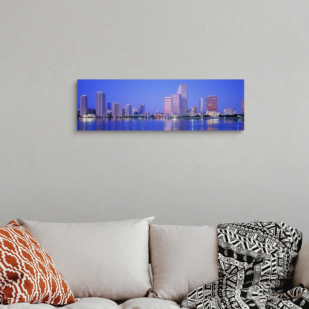A bohemian room featuring Landscape giant photograph of downtown Miami at night, with skyscraper and city light reflections...