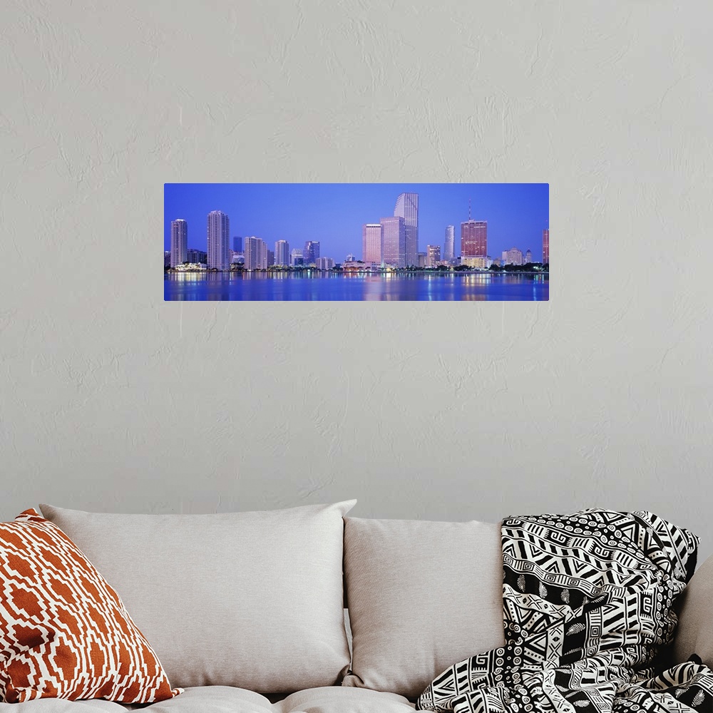 A bohemian room featuring Landscape giant photograph of downtown Miami at night, with skyscraper and city light reflections...