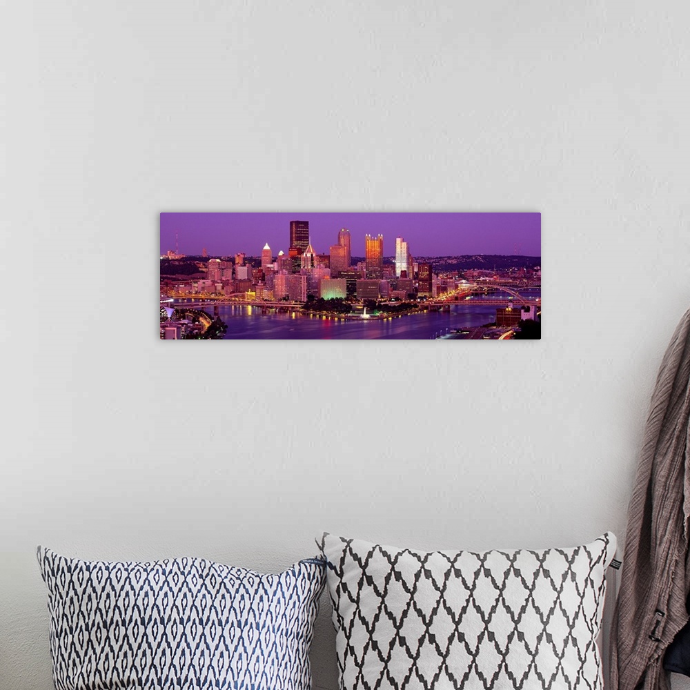 A bohemian room featuring Large print of a horizontal photograph of skyline in Pittsburgh, Pennsylvania at night.