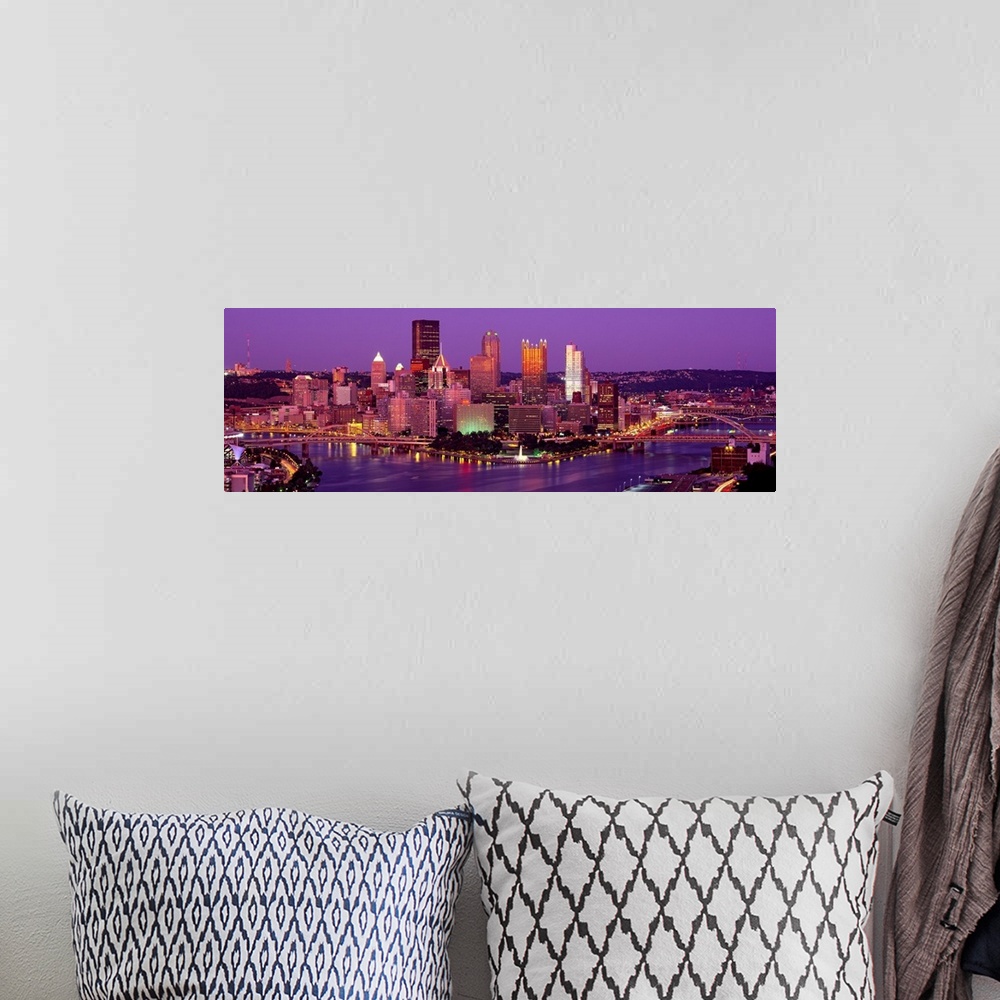 A bohemian room featuring Large print of a horizontal photograph of skyline in Pittsburgh, Pennsylvania at night.