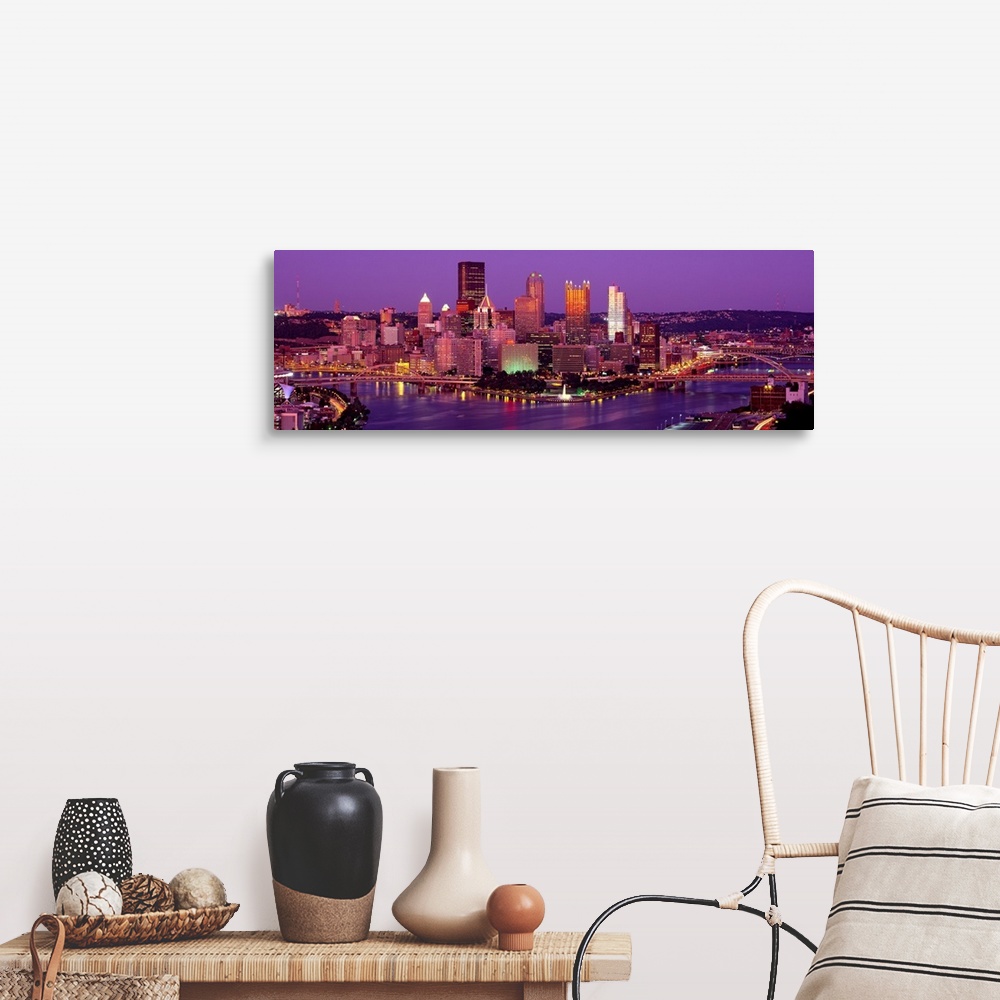 A farmhouse room featuring Large print of a horizontal photograph of skyline in Pittsburgh, Pennsylvania at night.