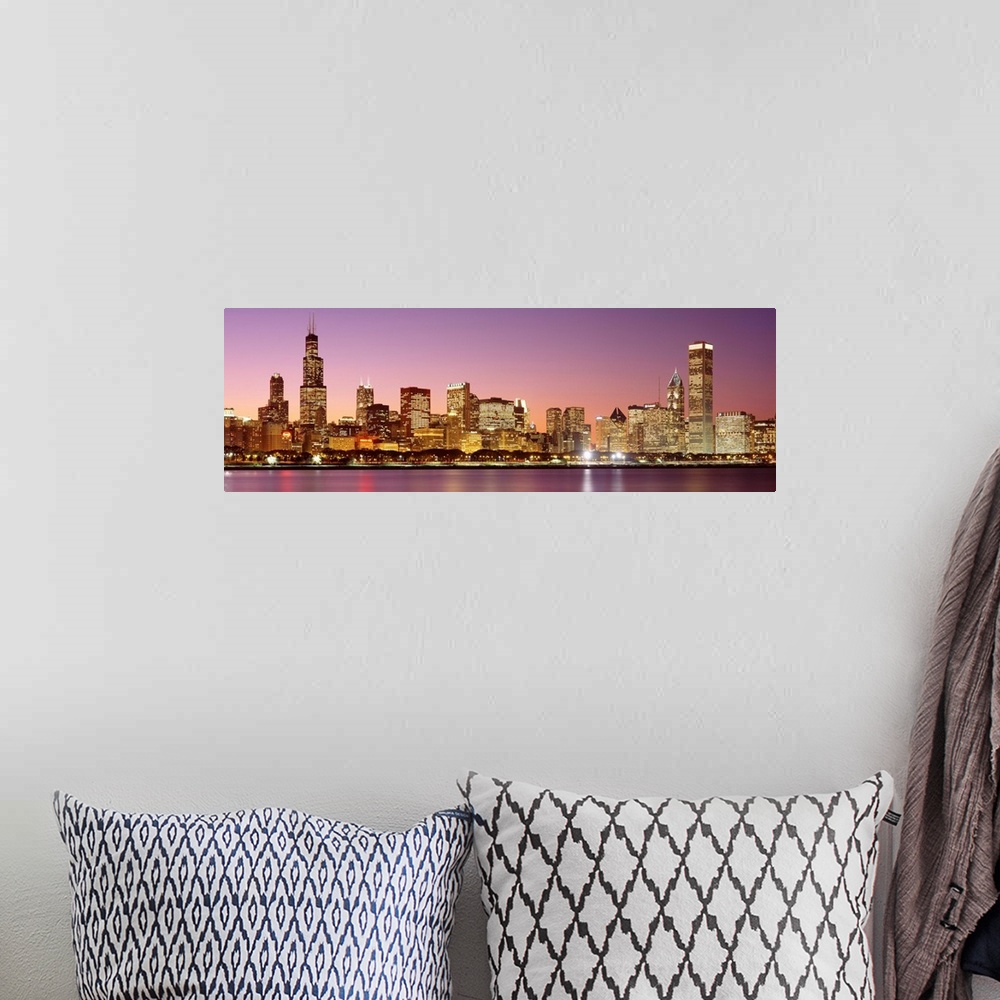 A bohemian room featuring A panoramic photograph of a skyscraper filled skyline taken at dusk in Chicago, Illinois.  The br...