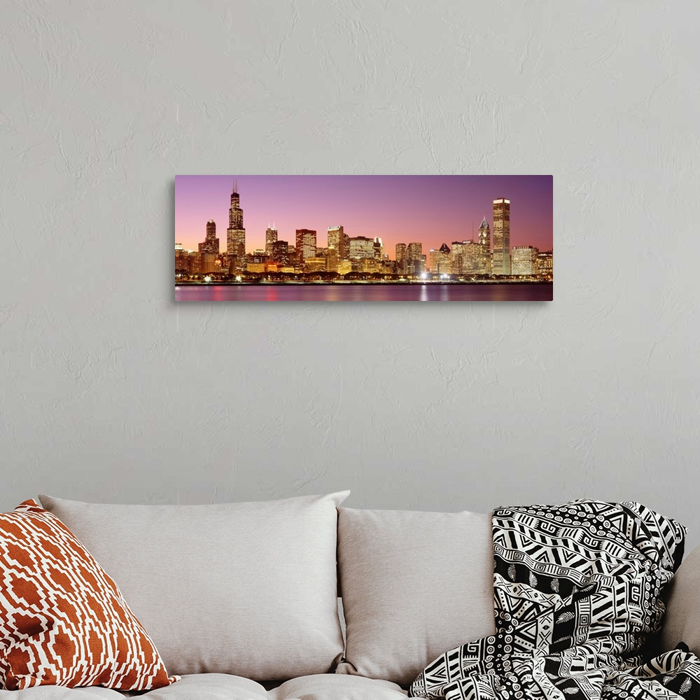 A bohemian room featuring A panoramic photograph of a skyscraper filled skyline taken at dusk in Chicago, Illinois.  The br...
