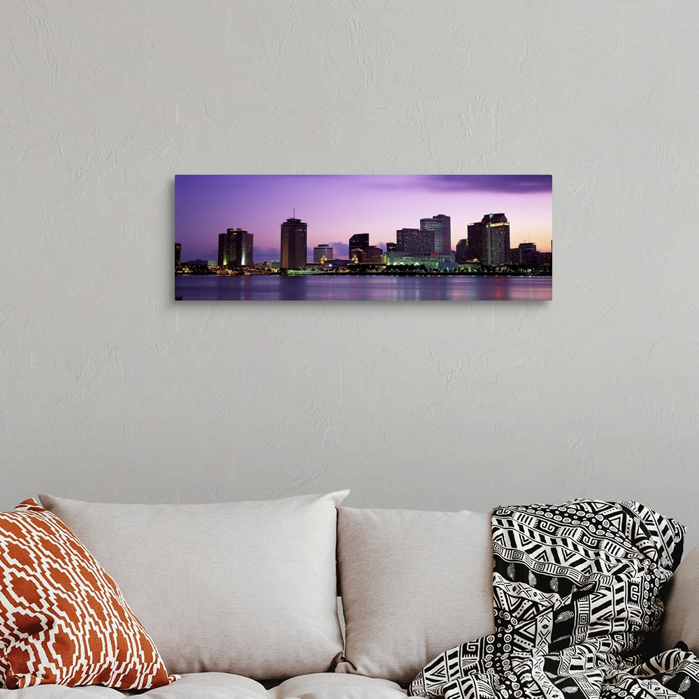 A bohemian room featuring Sunset panorama of the Downtown New Orleans skyline with the Mississippi River in the foreground.