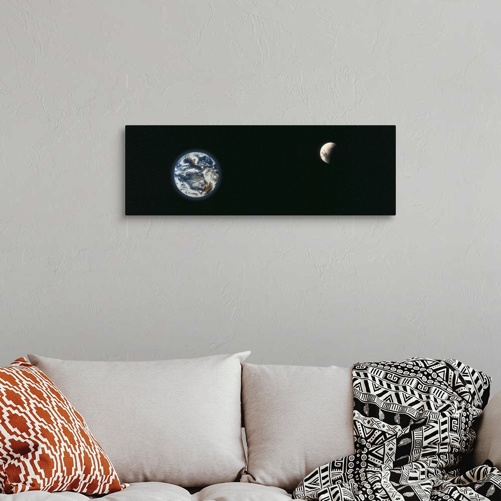 A bohemian room featuring A panoramic re-creation of the earth and a half shaded moon from outer space.