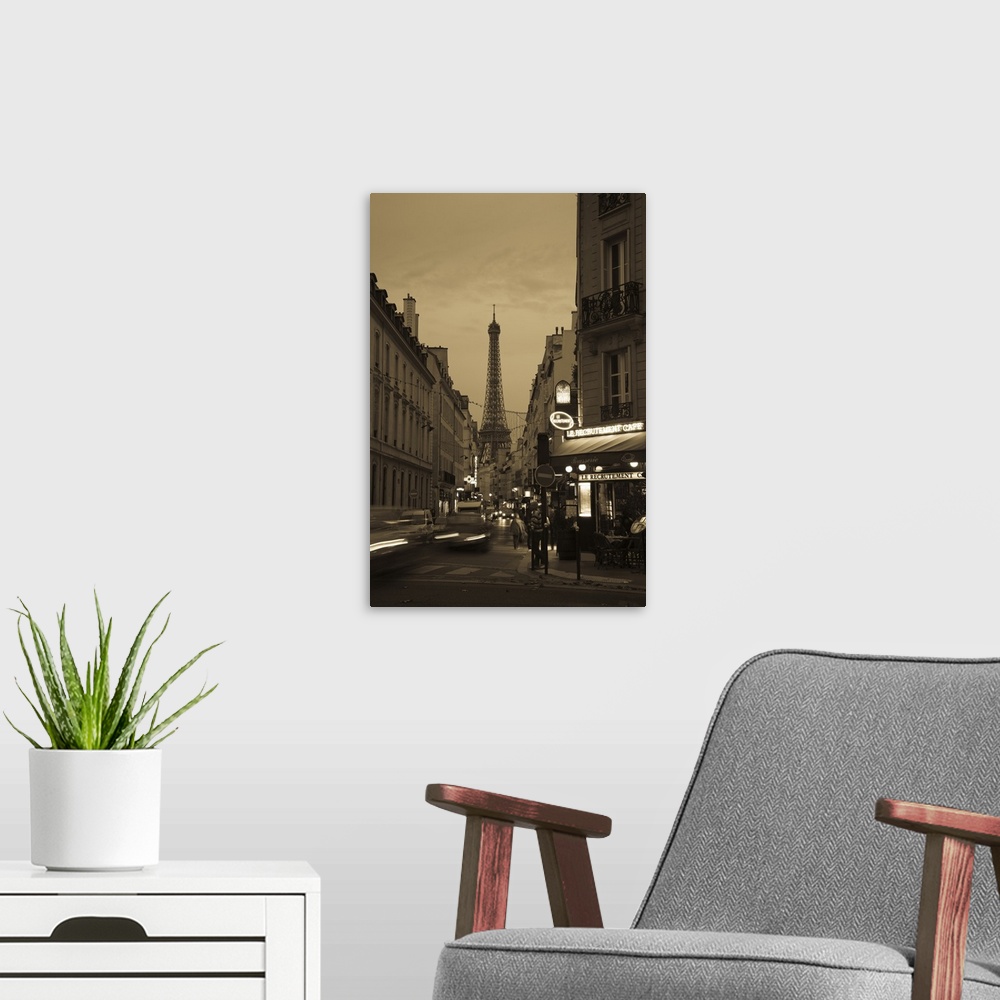 A modern room featuring Vertical photo on canvas of a street with the Eiffel Tower in the background at dusk.