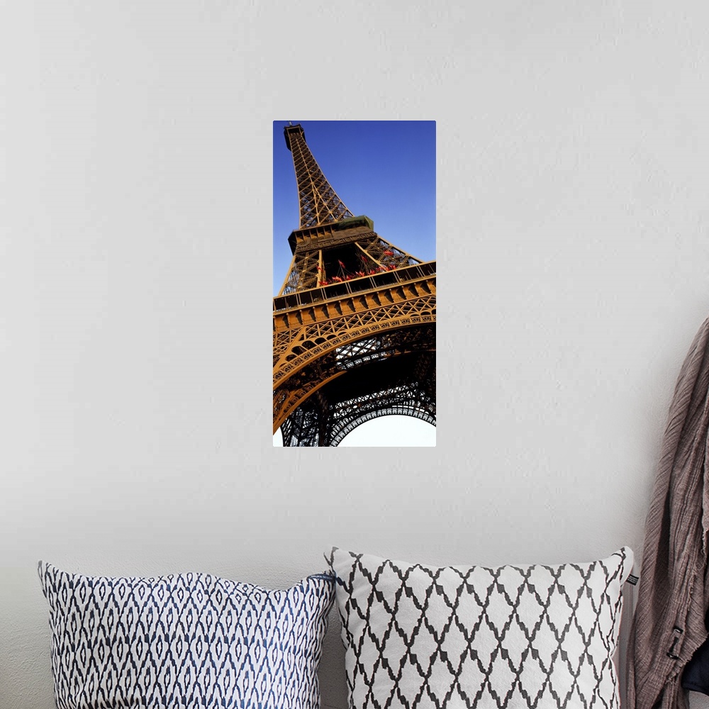 A bohemian room featuring Vertical, close up, low angle photograph of the Eiffel Tower against a blue sky.