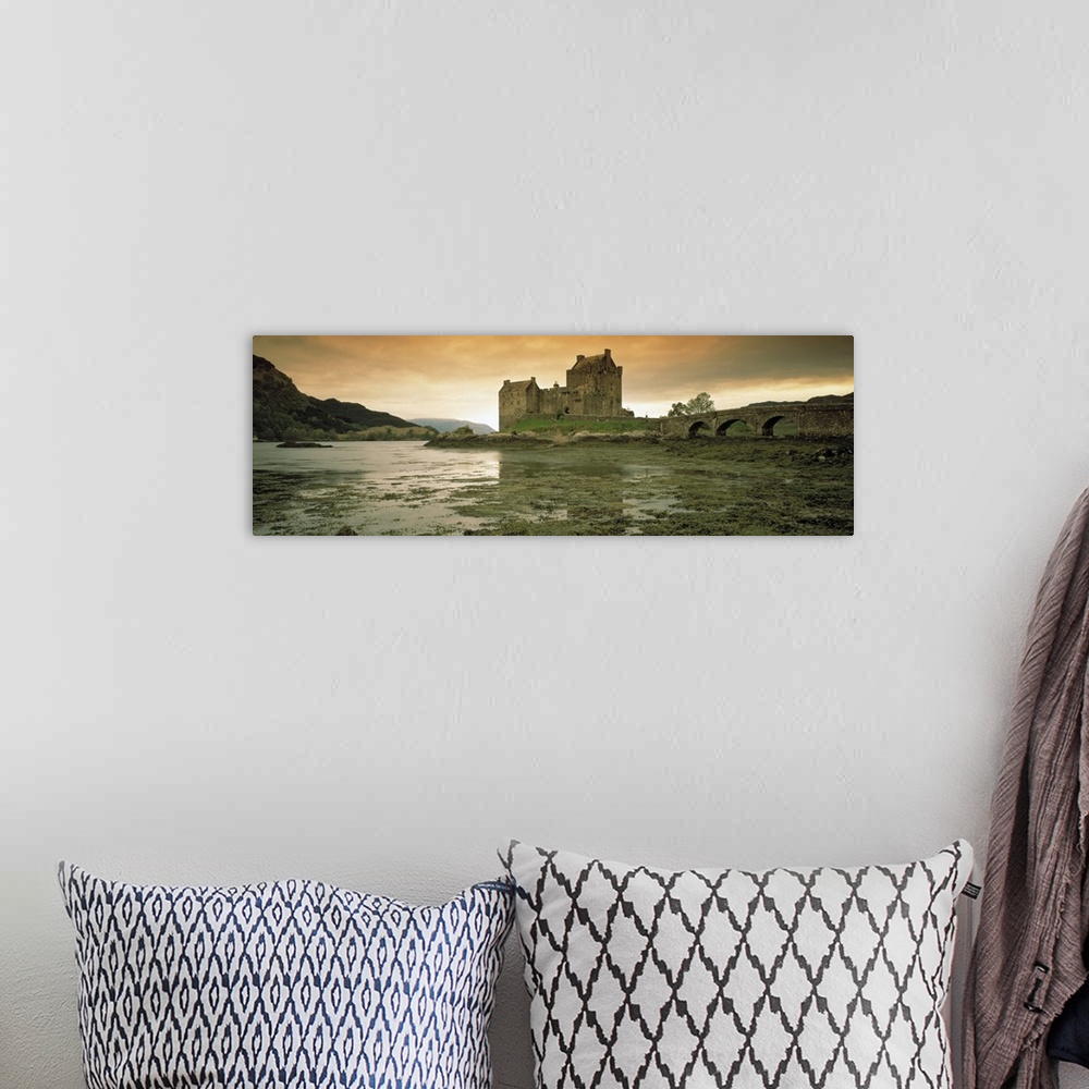 A bohemian room featuring Wide angle photograph taken of a castle in Scotland under a dusk sky with wet land shown in the f...