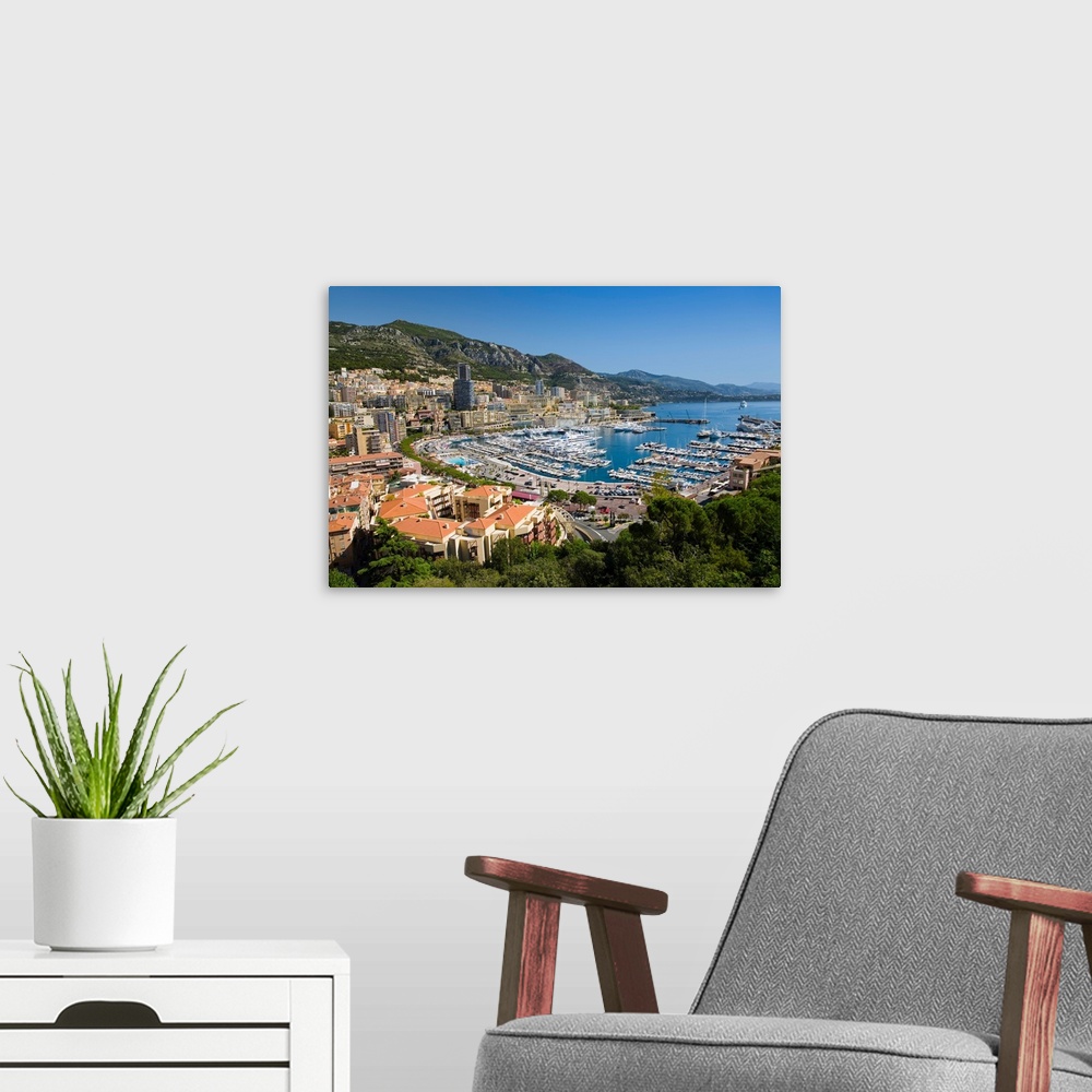 A modern room featuring Elevated view of Monte-Carlo and harbor in the Principality of Monaco, Western Europe on the Medi...