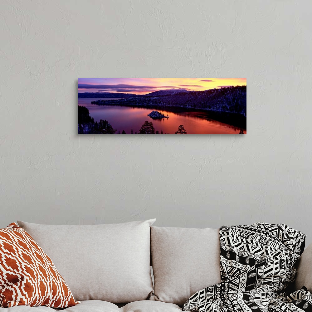 A bohemian room featuring Panoramic photograph of bay at sunset twisting through snow dusted mountains and trees.