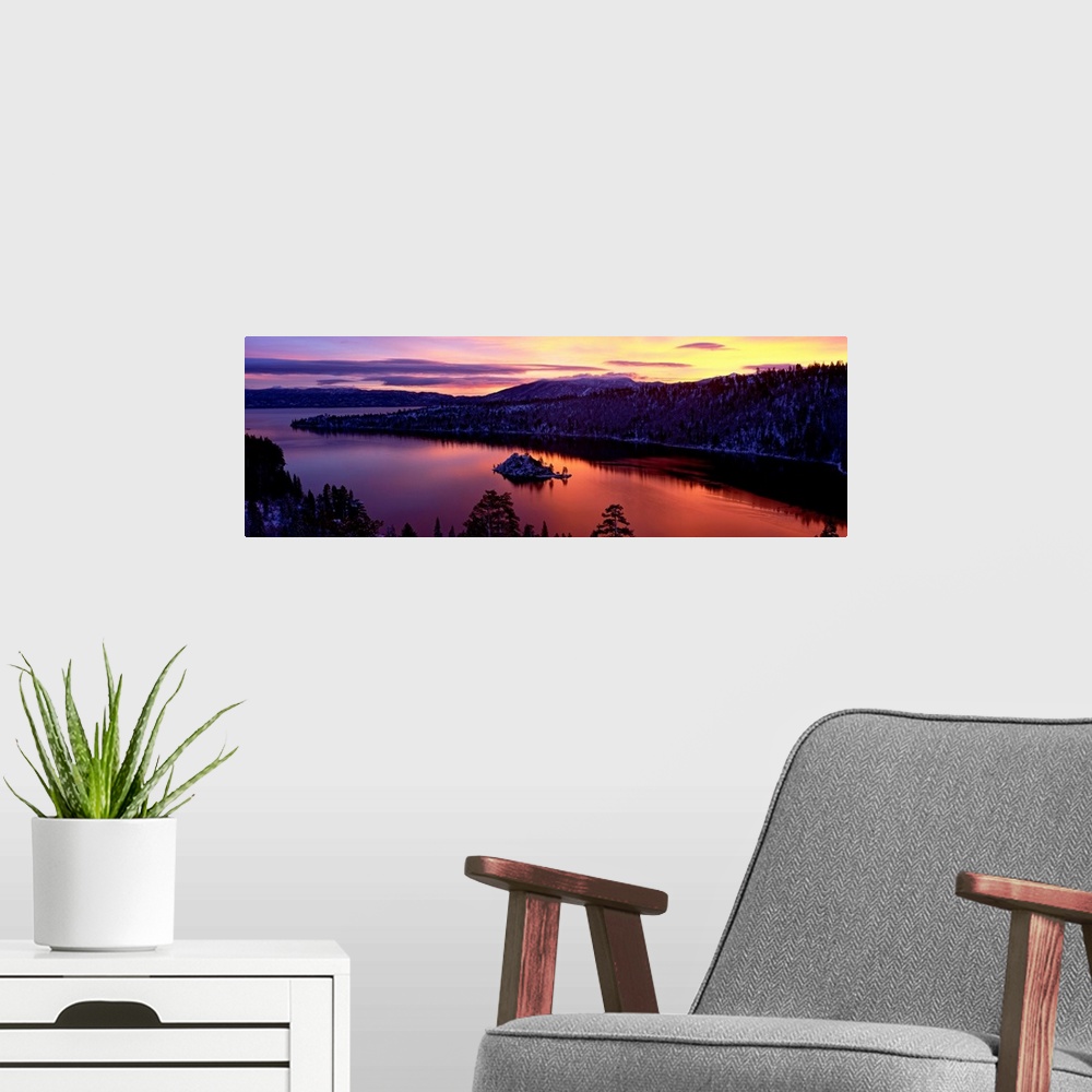 A modern room featuring Panoramic photograph of bay at sunset twisting through snow dusted mountains and trees.
