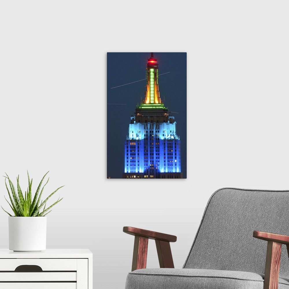 A modern room featuring Empire State Building lit up at night, Manhattan, New York City, New York State, USA