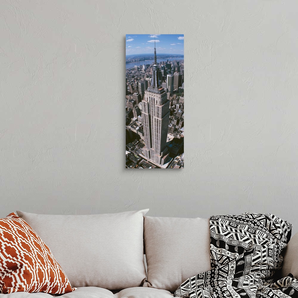 A bohemian room featuring Panoramic photograph taken from an aerial view focuses on a landmark skyscraper found within Manh...