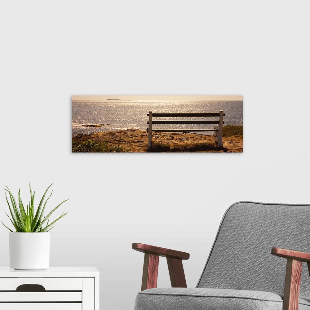 A modern room featuring Panoramic photo on canvas of an empty bench overlooking a beach in the northeast US.