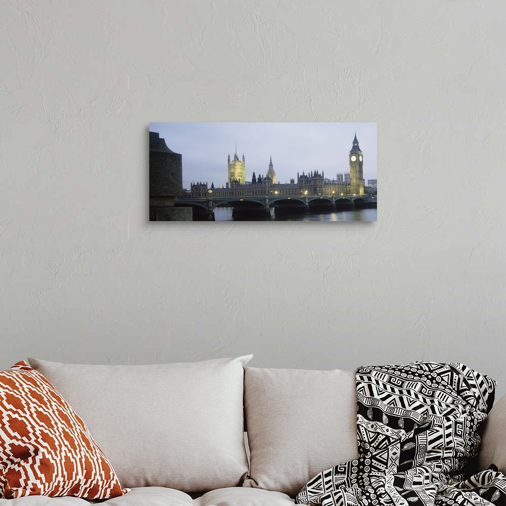 A bohemian room featuring This photograph is taken of parliament and the big ben clock tower in London during dusk.