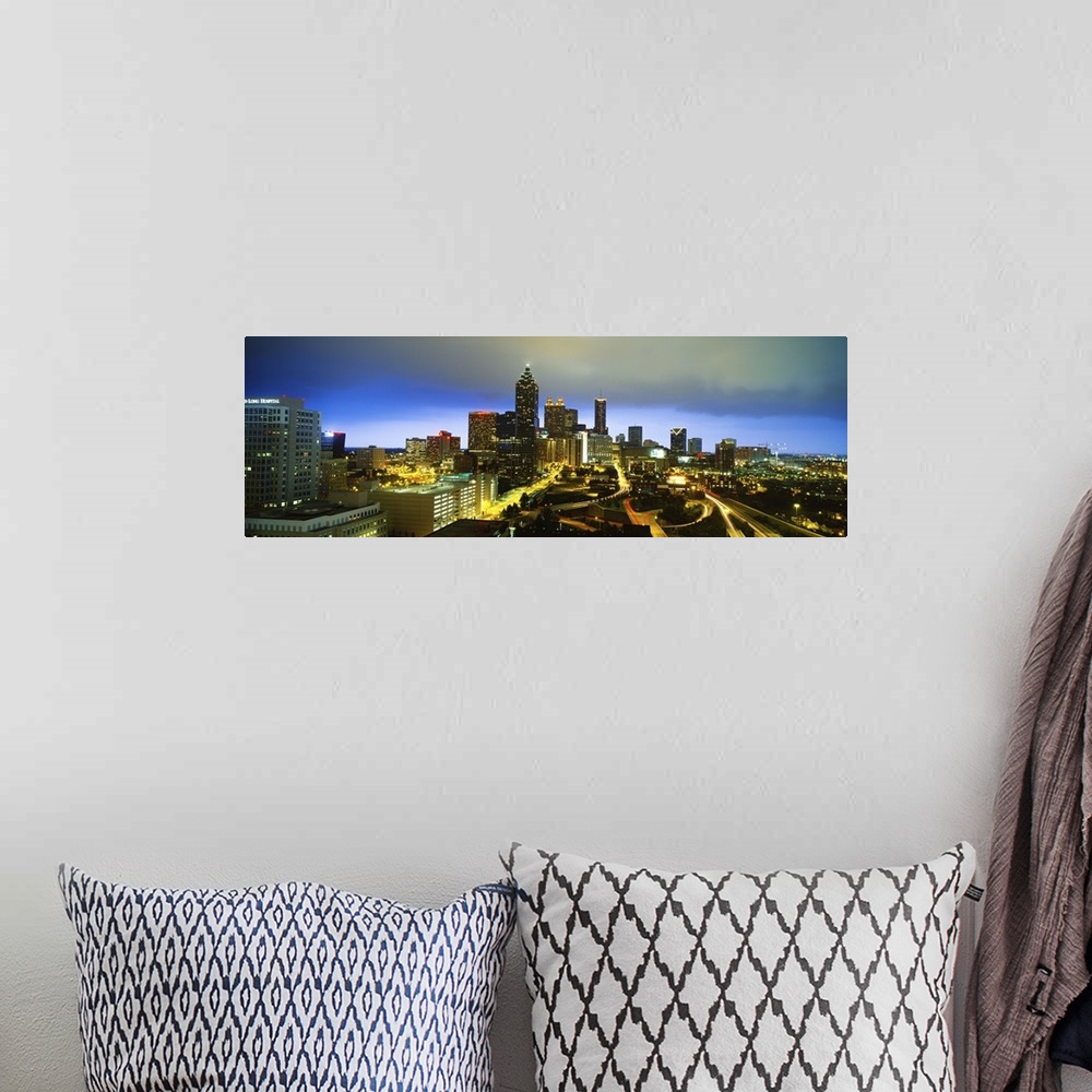 A bohemian room featuring Large horizontal photo on canvas of downtown Atlanta at night lit up.
