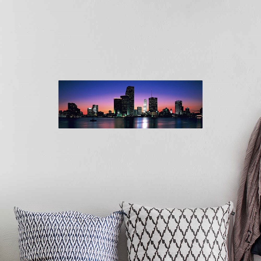A bohemian room featuring Giant, panoramic photograph of the Miami skyline at night, reflecting over the waters of Biscayne...