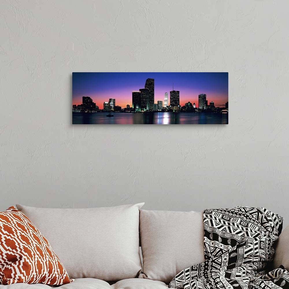 A bohemian room featuring Giant, panoramic photograph of the Miami skyline at night, reflecting over the waters of Biscayne...