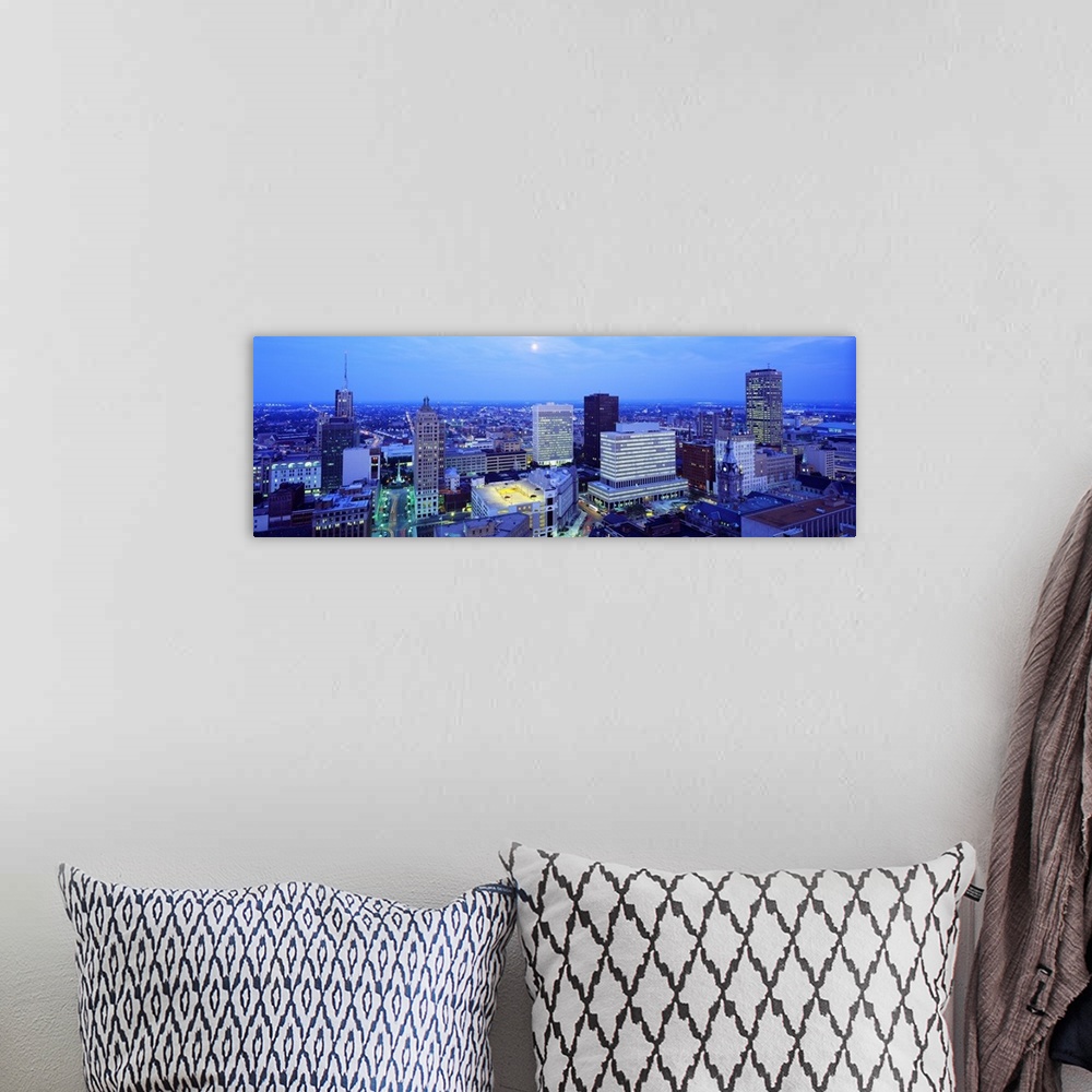 A bohemian room featuring This panoramic wall art is an aerial photograph of the city skyline at dusk with moon shining dow...
