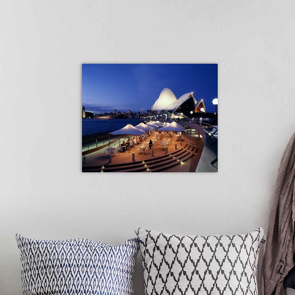 A bohemian room featuring A panorama of Sydney, Autralia's waterfront, featuring the Sydney Opera House and cafe.