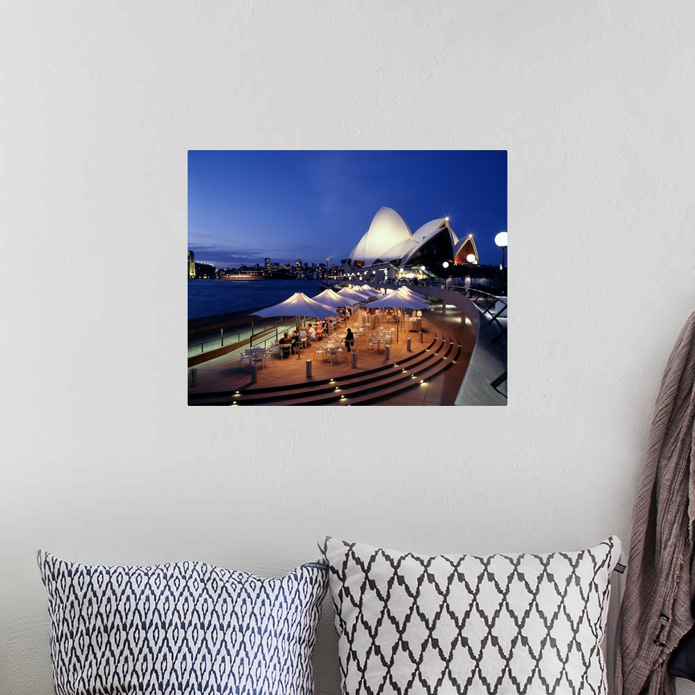 A bohemian room featuring A panorama of Sydney, Autralia's waterfront, featuring the Sydney Opera House and cafe.