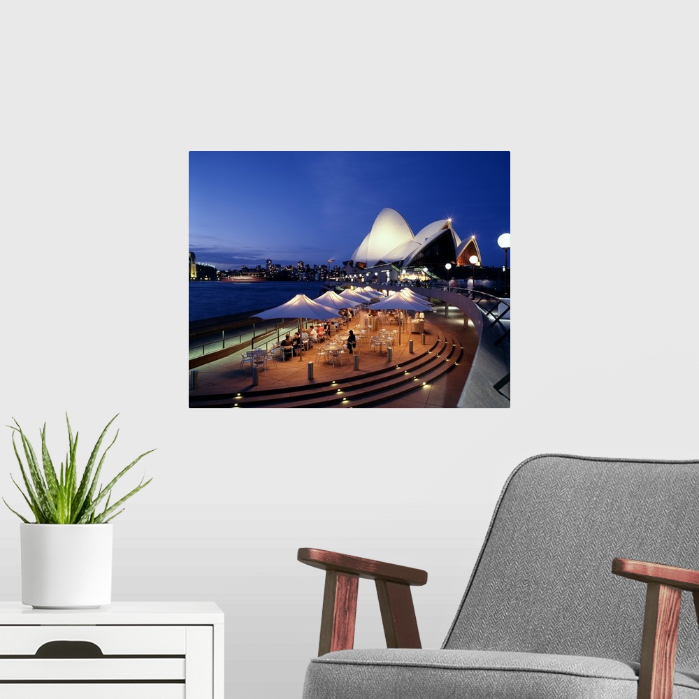 A modern room featuring A panorama of Sydney, Autralia's waterfront, featuring the Sydney Opera House and cafe.