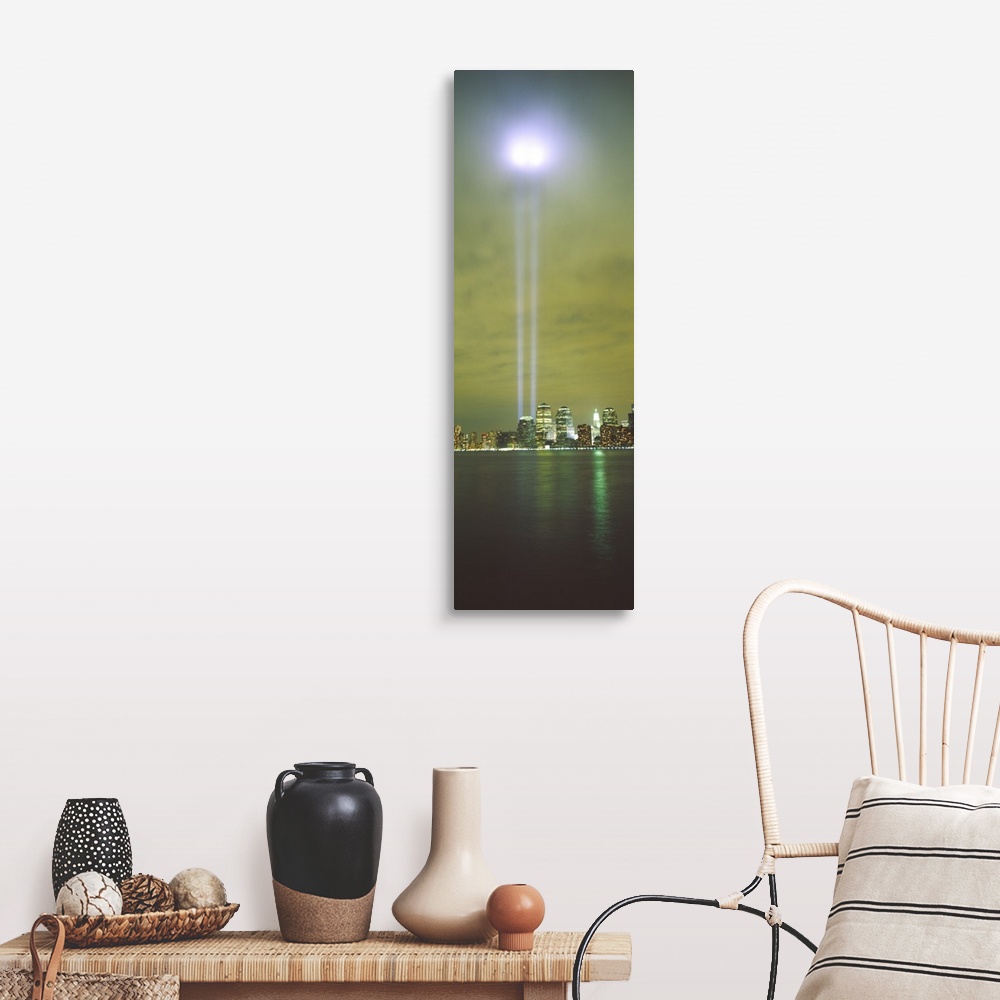 A farmhouse room featuring Vertical panoramic piece of a photograph of the lights shining up from where the twin towers stood.