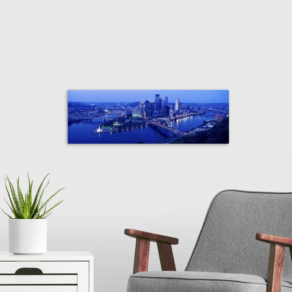 A modern room featuring Panoramic evening view of Pittsburgh, PA with West End Bridge, and Allegheny, Monongahela and Ohi...